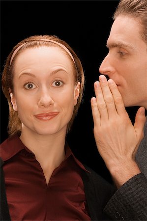 simsearch:625-02931286,k - Close-up of a businessman whispering into a businesswoman's ear Stock Photo - Premium Royalty-Free, Code: 625-02932935