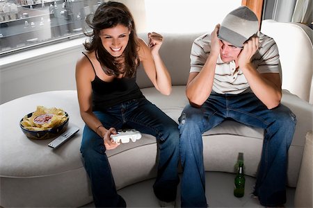 Young Cute Competitive Boyfriend Girlfriend Playing Video Games In Couch  Stock Photo, Picture and Royalty Free Image. Image 34313215.