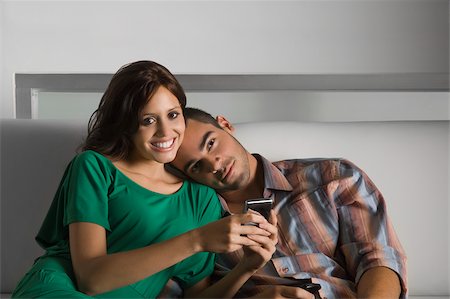 phone young caucasian woman relaxed - Portrait of a young woman holding a mobile phone and a young man leaning on her shoulder Stock Photo - Premium Royalty-Free, Code: 625-02932953