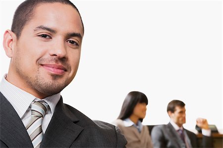 simsearch:625-02929907,k - Portrait of a businessman smiling with other business executives in a board room Stock Photo - Premium Royalty-Free, Code: 625-02933005