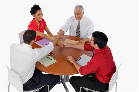 High angle view of three businessmen and a businesswoman shaking hands Stock Photo - Premium Royalty-Free, Code: 625-02933018