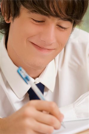 Close-up of a high school student writing in a notebook Stock Photo - Premium Royalty-Free, Code: 625-02933072