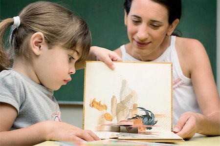 friends advice two female - Female teacher teaching her student in a classroom Stock Photo - Premium Royalty-Free, Code: 625-02933081