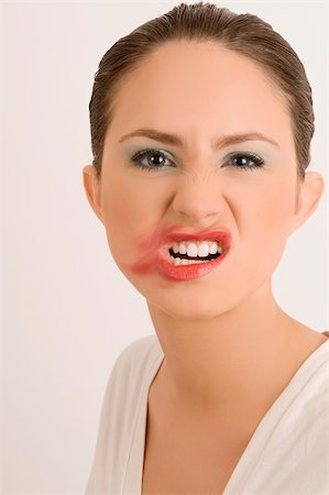 distaste - Portrait of a young woman with her messy lips Stock Photo - Premium Royalty-Free, Code: 625-02933083