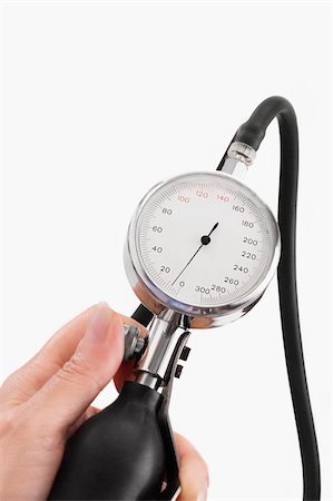 Close-up of a person's hand holding a blood pressure gauge Stock Photo - Premium Royalty-Free, Code: 625-02933227