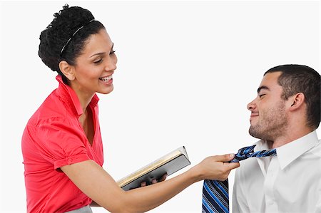 Businesswoman pulling a businessman with his tie and smiling Stock Photo - Premium Royalty-Free, Code: 625-02933231