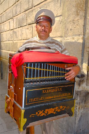Portrait of a mature man holding a harmonipan, Mexico City, Mexico Stock Photo - Premium Royalty-Free, Code: 625-02933376