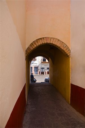 Alley passing through an archway, Alcaiceria De Gomez, Zacatecas State, Mexico Stock Photo - Premium Royalty-Free, Code: 625-02933459