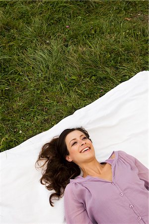 simsearch:628-07072108,k - Happy woman lying on blanket in grass, Munich, Bavaria, Germany Stock Photo - Premium Royalty-Free, Code: 628-05817197