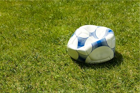 flat soccer ball - Flat soccer ball in grass, Germany Stock Photo - Premium Royalty-Free, Code: 628-05817334