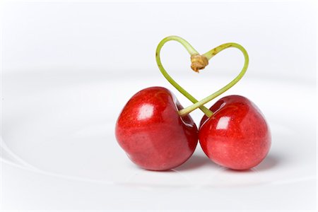 Two cherries interlocked in heart-shape, Germany Stock Photo - Premium Royalty-Free, Code: 628-05817352