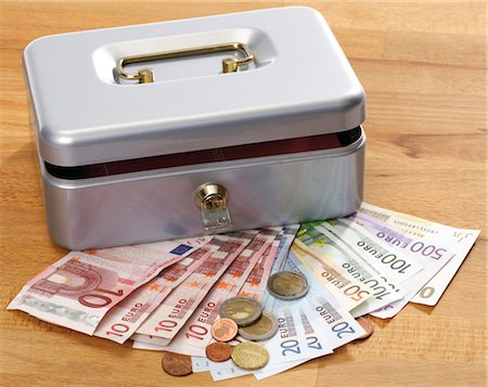 simsearch:614-06813505,k - Money in front of a cash box Stock Photo - Premium Royalty-Free, Code: 628-05817408