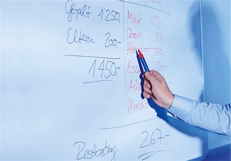 price - Financial advisor at whiteboard calculating home finances Stock Photo - Premium Royalty-Free, Code: 628-05817538
