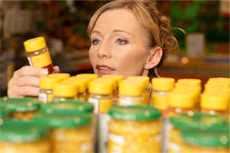 read food label - Woman choosing spices in a supermarket Stock Photo - Premium Royalty-Free, Code: 628-05817560