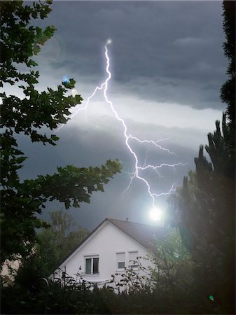 dark storming sky - Lightning strikes into house Stock Photo - Premium Royalty-Free, Code: 628-05817574