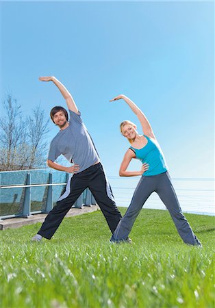 simsearch:6115-06778925,k - Man and woman doing gymnastics in meadow Foto de stock - Sin royalties Premium, Código: 628-05817584