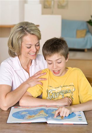 Mother and son looking into atlas Stock Photo - Premium Royalty-Free, Code: 628-05817595