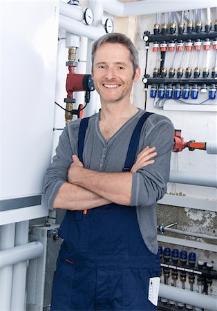 Electrician standing at heating system Stock Photo - Premium Royalty-Free, Code: 628-05817607