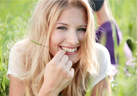 simsearch:628-07072360,k - Happy young woman lying in meadow Stock Photo - Premium Royalty-Free, Code: 628-05817649