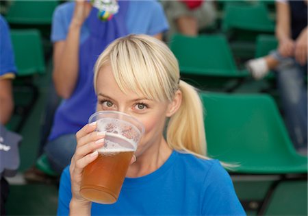 fan stadium woman - Female fan drinking beer in a stadium Stock Photo - Premium Royalty-Free, Code: 628-05817773