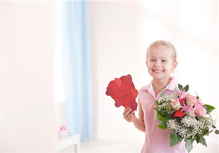 fête des mères - Jeune fille souriante tenant à coeur et bouquet de fleurs Photographie de stock - Premium Libres de Droits, Code: 628-05817809