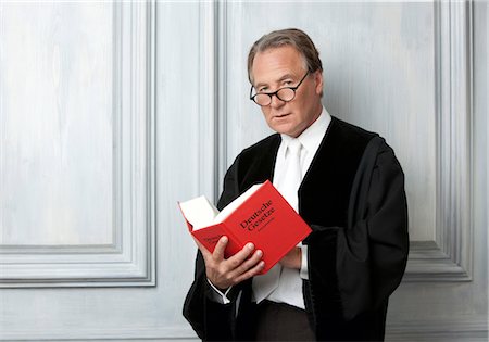 Judge reading code law Stock Photo - Premium Royalty-Free, Code: 628-05817851