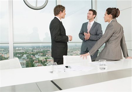 simsearch:628-05817960,k - Three businesspeople having a meeting Stock Photo - Premium Royalty-Free, Code: 628-05817900