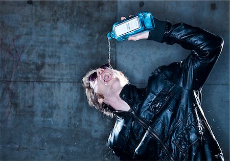 pour of liquor - Man pouring hard liquor into his mouth Stock Photo - Premium Royalty-Free, Code: 628-05817903