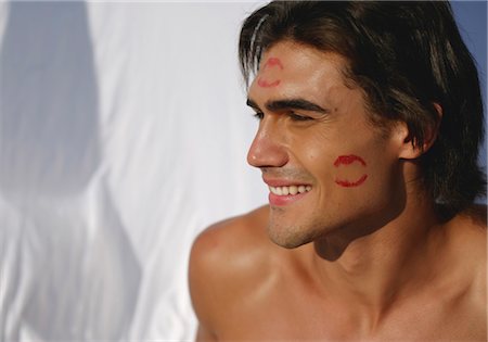 ruegen - Young man with lipstick marks in the face Fotografie stock - Premium Royalty-Free, Codice: 628-05817932