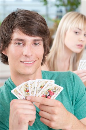 Couple playing cards, Munich, Bavaria, Germany Stock Photo - Premium Royalty-Free, Code: 628-05818087