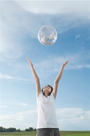 safe world - Girl playing with transparent globe outdoors Stock Photo - Premium Royalty-Free, Code: 628-07072089