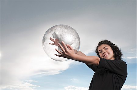 Girl holding transparent globe outdoors Stock Photo - Premium Royalty-Free, Code: 628-07072080