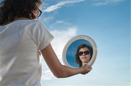 sunglasses on head - Girl outdoors holding mirror Stock Photo - Premium Royalty-Free, Code: 628-07072099