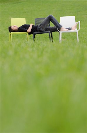 foot on chair - Girl sleeping on plastic chairs in meadow Stock Photo - Premium Royalty-Free, Code: 628-07072121