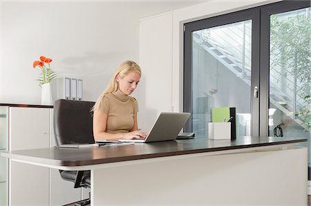 simsearch:400-08838779,k - Businesswoman using laptop at desk Stock Photo - Premium Royalty-Free, Code: 628-07072136