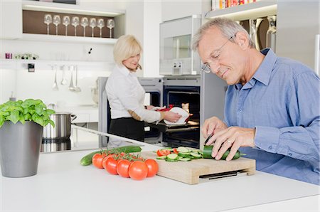preparing food - Senior couple preparing healthy meal in kitchen Stock Photo - Premium Royalty-Free, Code: 628-07072156