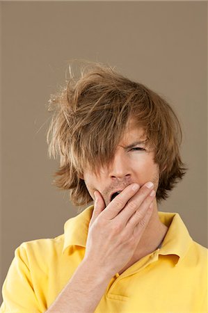 simsearch:628-07072584,k - Tired man in yellow polo shirt Stock Photo - Premium Royalty-Free, Code: 628-07072179