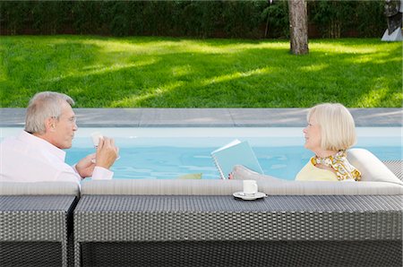 Senior couple drinking espresso by the poolside Stock Photo - Premium Royalty-Free, Code: 628-07072170