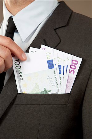 simsearch:628-07072186,k - Businessman grasping in jacket pocket with Euro notes Stock Photo - Premium Royalty-Free, Code: 628-07072191