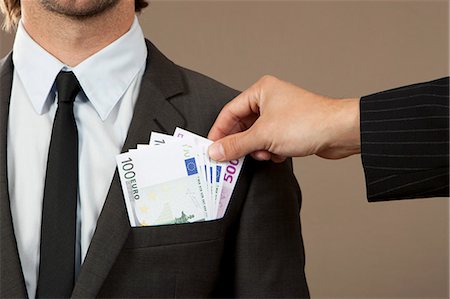 euro - Hand grasping in jacket pocket with Euro notes Stock Photo - Premium Royalty-Free, Code: 628-07072192