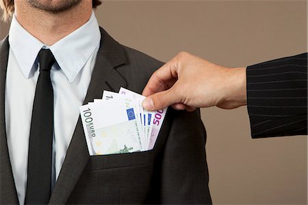 Hand grasping in jacket pocket with Euro notes Stockbilder - Premium RF Lizenzfrei, Bildnummer: 628-07072192