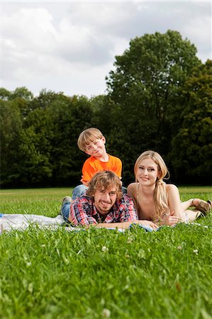 father son lying grass - Happy family lying on blanket in meadow Stock Photo - Premium Royalty-Free, Code: 628-07072294