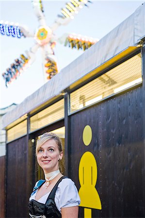 Woman standing in front of the women's restroom on the Oktoberfest in Munich, Bavaria, Germany Photographie de stock - Premium Libres de Droits, Code: 628-07072375