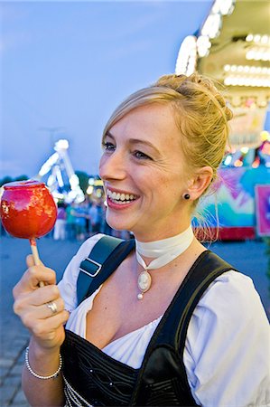 european traditional clothing - Woman holding candy apple on the Oktoberfest in Munich, Bavaria, Germany Stock Photo - Premium Royalty-Free, Code: 628-07072377