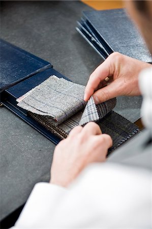 simsearch:628-07072456,k - Man in a tailor studio looking at fabric swatches Photographie de stock - Premium Libres de Droits, Code: 628-07072393