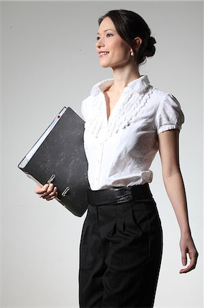 Businesswoman holding folder Stock Photo - Premium Royalty-Free, Code: 628-07072423