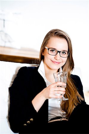 Smiling teenage girl holding glass of water Stock Photo - Premium Royalty-Free, Code: 628-07072454