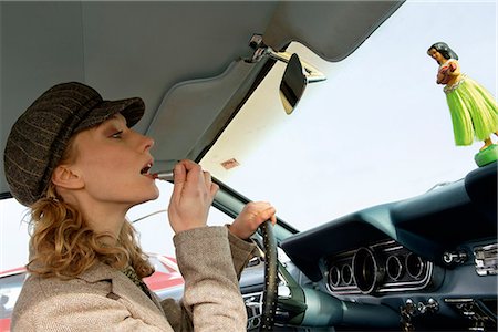 drive old car - Woman in car applying lipstick Stock Photo - Premium Royalty-Free, Code: 628-07072508