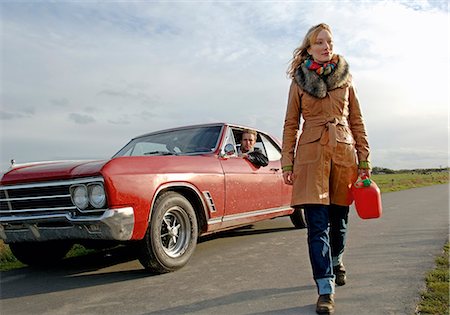 street man car - Woman walking with fuel can on country road Stock Photo - Premium Royalty-Free, Code: 628-07072509