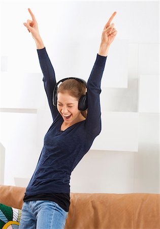 singing with head phone - Jolly young woman with headphones Stock Photo - Premium Royalty-Free, Code: 628-07072510